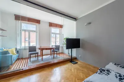 a bedroom with a table and chairs and a tv at Modern apartment few steps from centre in Prague