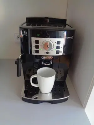 a coffee maker with a cup on a stand at Modern apartment few steps from centre in Prague