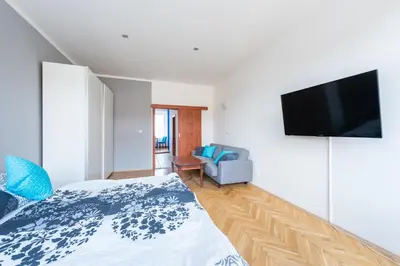 a bedroom with a bed and a flat screen tv at Bright apartment few steps from centre in Prague