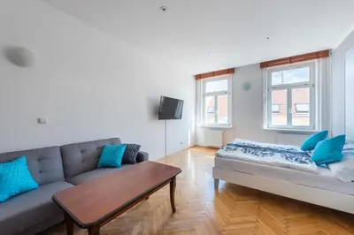 a living room with a couch and a table at Bright apartment few steps from centre in Prague