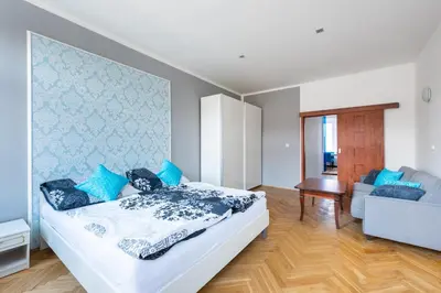 a bedroom with a bed and a living room at Bright apartment few steps from centre in Prague