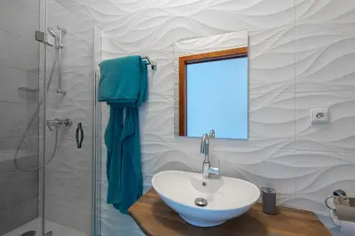 a bathroom with a sink and a shower at Bright apartment few steps from centre in Prague