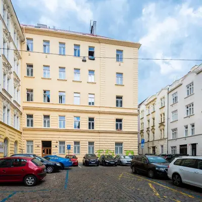 a large building with cars parked in front of it at Bright apartment few steps from centre in Prague