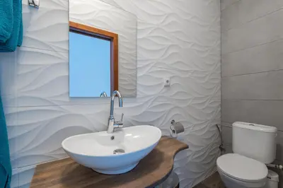 a bathroom with a white sink and a toilet at Bright apartment few steps from centre in Prague