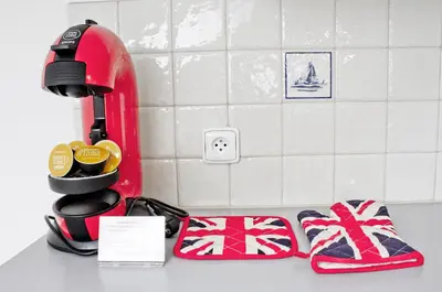 a kitchen counter with a red mixer and a pair of slippers at Royal Court Legerova in Prague