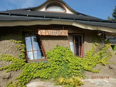 a large house with people standing outside of it at Hotel Zámek Berchtold in Kunice - Vidovice