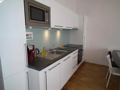a small kitchen with a sink and a microwave at Old Town spacious apartment in Prague