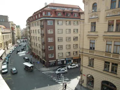 a city street with cars parked in front of buildings at Old Town spacious apartment in Prague