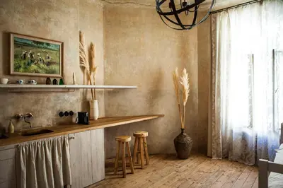 a kitchen with a counter and stools and a window at The Emerald in Prague
