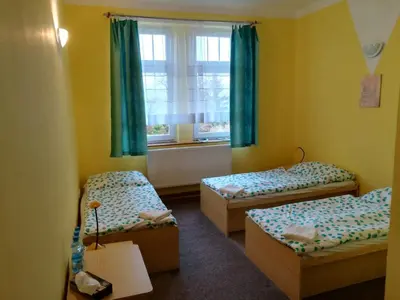 a room with two beds and a window at Hotel Modrá hvězda Sadská in Sadská