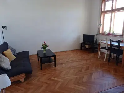 a living room with a couch and a table at Big family apartment in Prague