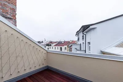 a balcony with a view of some buildings at Wishlist Prague Residences - Vinohrady in Prague