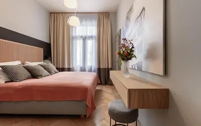a bedroom with a bed and a vase of flowers at Wishlist Prague Residences - Vinohrady in Prague