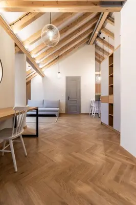 a living room with a table and a couch at Wishlist Prague Residences - Vinohrady in Prague