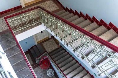 an overhead view of a staircase with a metal railing at Wishlist Prague Residences - Vinohrady in Prague