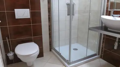 a bathroom with a shower and a toilet and a sink at Penzion Coupe in Příbram