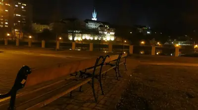 a couple of benches sitting in a park at night at Penzion Coupe in Příbram