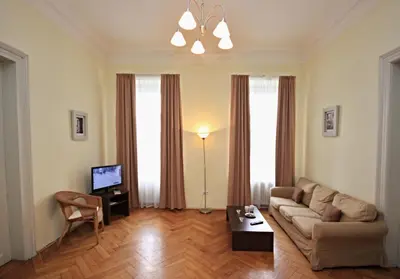 a living room with a couch and a tv at River View Residence in Prague