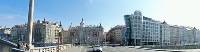 a city street with buildings and cars on a bridge at River View Residence in Prague