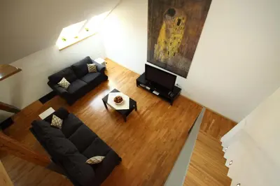 an overhead view of a living room with a couch and a tv at River View Residence in Prague