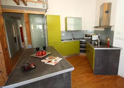 a kitchen with green cabinets and a counter top at River View Residence in Prague