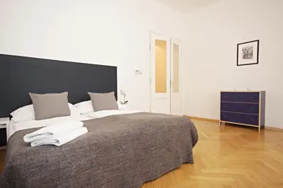 a bedroom with a large bed with two towels on it at Prague Central Residence in Prague