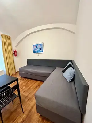 a living room with a couch and a table at Prague Central Residence in Prague