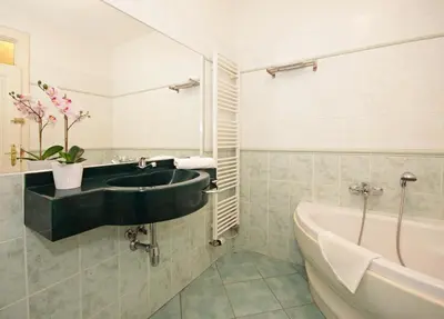 a bathroom with a sink and a bath tub at Prague Central Residence in Prague