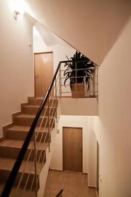 a staircase with a potted plant in a house at Pension Nika in Prague