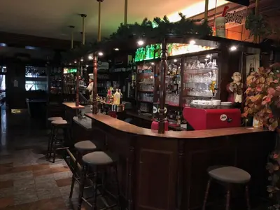 a bar in a restaurant with stools at Hotel V Pivovaře Davle in Davle