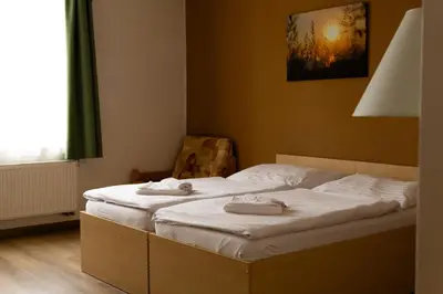 a bedroom with two beds with towels on them at Pension Fontana in Poděbrady