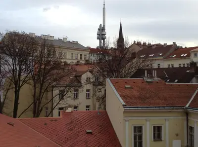 a bedroom with a bed with two towels on it at Hotel Victor in Prague