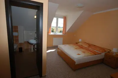 a bedroom with a bed and a sink and a window at Toscca in Čelákovice