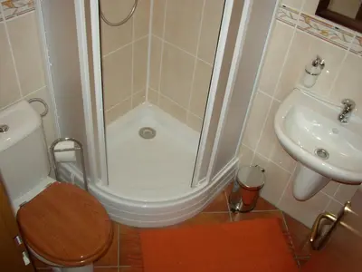 a bathroom with a shower and a toilet and a sink at Pension a Restaurace Vyhlídka in Karlštejn