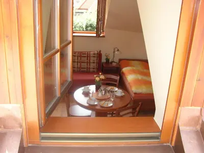 a small room with a table and a couch at Pension a Restaurace Vyhlídka in Karlštejn