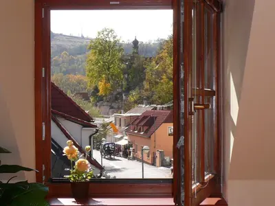 an open window with a view of a city at Pension a Restaurace Vyhlídka in Karlštejn