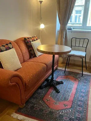 a living room with a couch and a table at Apartments Emma in Prague