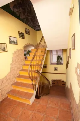 a staircase in a house with a stone wall at Pension Centrum in Ricany