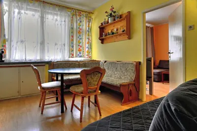 a living room with a table and chairs and a couch at Apartments Letna in Prague