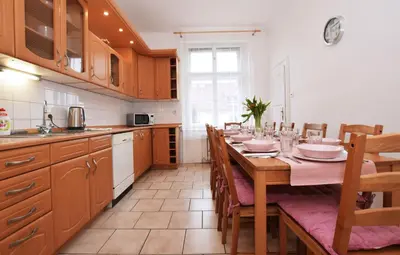 a kitchen with a long table with chairs and a tableasteryasteryasteryasteryastery at Flamingo Apartments in Prague