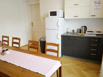 a kitchen with a table and a white refrigerator at Flamingo Apartments in Prague