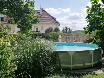 a hot tub in the yard of a house at Flamingo Apartments in Prague