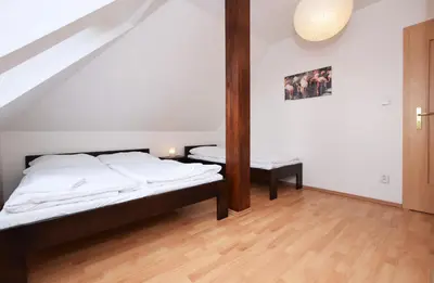 a bedroom with a bed and a table in it at Flamingo Apartments in Prague