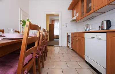 a kitchen with a table and chairs and a counter at Flamingo Apartments in Prague
