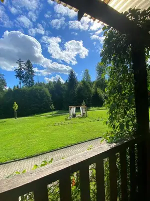 a view from a porch of a field with a shed at Resort Lesní Lázně in Zvánovice