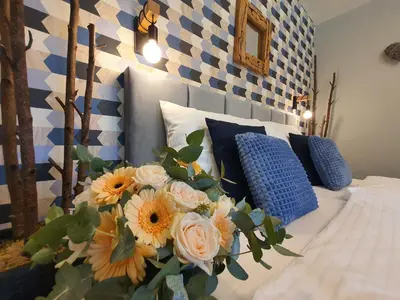 a bedroom with a bed with flowers on it at Resort Lesní Lázně in Zvánovice