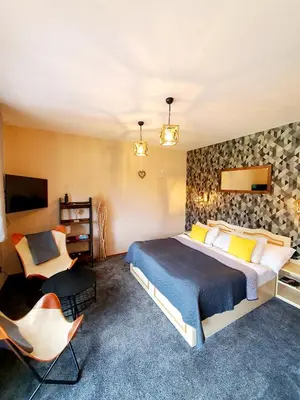 a bedroom with a bed with yellow and white flowers at Resort Lesní Lázně in Zvánovice