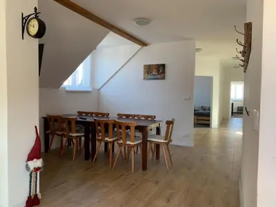 a dining room with a table and chairs at U mě v domě 26 in Dubá