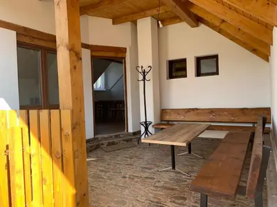 a room with a wooden bench and a table at U mě v domě 26 in Dubá