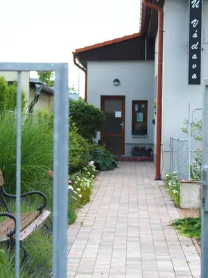 a walkway in front of a building with a door at Apartmány U Václava - 7 minut od letiště Václava Havla - parkování zdarma in Kněževes